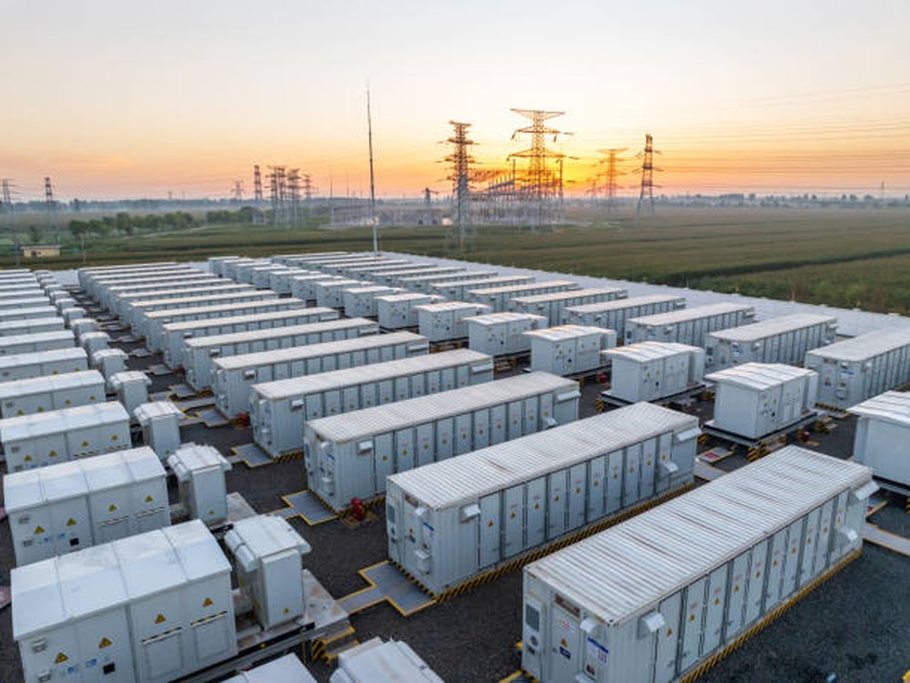 Containerized battery energy storage units installed in rows at a power site